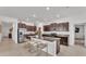 Modern kitchen features dark cabinetry, granite countertops, stainless steel appliances, and a spacious island with seating at 2991 Flying Blackbird Rd, Bartow, FL 33830