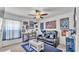 Cozy living room with reclining love seat, fan cave, and posters at 2991 Flying Blackbird Rd, Bartow, FL 33830