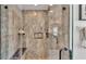Close-up of a tiled shower featuring a glass enclosure, built-in shelves, and modern fixtures at 2991 Flying Blackbird Rd, Bartow, FL 33830