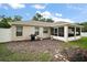 The backyard features a BBQ, a small eating area and a screened-in lanai at 305 Woods Landing Dr, Lady Lake, FL 32159