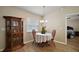 Bright dining area with hardwood floors and decorative cabinet at 305 Woods Landing Dr, Lady Lake, FL 32159
