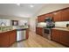 Spacious kitchen with stainless steel appliances, granite counters, and wood-look floors at 305 Woods Landing Dr, Lady Lake, FL 32159