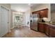 Eat-in kitchen with natural light, stainless steel refrigerator, and wood-look flooring at 305 Woods Landing Dr, Lady Lake, FL 32159