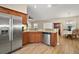 Open kitchen featuring stainless steel appliances, granite counters, and wood-look flooring at 305 Woods Landing Dr, Lady Lake, FL 32159