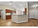 Bright kitchen features wood cabinets, granite countertops and stainless steel appliances at 305 Woods Landing Dr, Lady Lake, FL 32159