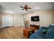 Living room featuring vaulted ceilings, a ceiling fan, and a rocking chair at 305 Woods Landing Dr, Lady Lake, FL 32159