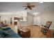 Open-concept living room with kitchen and dining area, and a blue couch at 305 Woods Landing Dr, Lady Lake, FL 32159