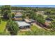 Home featuring a metal roof and a backyard pool enclosed by a fence, surrounded by lush green trees at 317 S 8Th St, Haines City, FL 33844