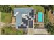 Aerial view of home showing pool, solar panels, and backyard at 317 S 8Th St, Haines City, FL 33844