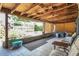 Cozy covered back patio with views of spa, seating, and backyard at 317 S 8Th St, Haines City, FL 33844