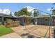 Backyard with patio, wooden fence, and house with solar panels at 317 S 8Th St, Haines City, FL 33844
