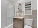 Cozy bathroom featuring a vanity with storage, shower with sliding glass door, and convenient built-in shelves at 317 S 8Th St, Haines City, FL 33844