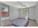 Well-lit bedroom with two windows, a ceiling fan, and a comfortable mattress on the floor at 317 S 8Th St, Haines City, FL 33844