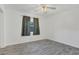 Simple bedroom featuring vinyl floors, ceiling fan, and natural light from the window at 317 S 8Th St, Haines City, FL 33844