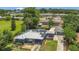Charming home with a metal roof, solar panels, and a well-manicured front lawn, complemented by green surroundings at 317 S 8Th St, Haines City, FL 33844