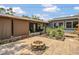 Exterior view of a cozy patio with fire pit and beautiful landscaping at 317 S 8Th St, Haines City, FL 33844