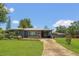 Inviting home with a well-manicured lawn, charming landscaping, and a covered porch, showcasing its curb appeal at 317 S 8Th St, Haines City, FL 33844