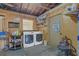 Functional laundry room with a washer, dryer, storage shelves, and a speed limit sign at 317 S 8Th St, Haines City, FL 33844