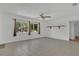Bright living room with neutral tile flooring, ceiling fan, and large windows for ample natural light at 317 S 8Th St, Haines City, FL 33844