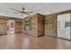 Inviting living room featuring wood plank accent walls, modern flooring, and doors leading to other spaces at 317 S 8Th St, Haines City, FL 33844