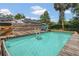 Backyard pool with wooden deck and solar panels on house at 317 S 8Th St, Haines City, FL 33844