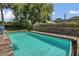 Inviting pool with wooden deck and ladder in a private backyard setting at 317 S 8Th St, Haines City, FL 33844