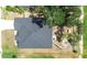 Aerial view of the roof and backyard with mature trees and fire pit at 3281 Enclave Blvd, Mulberry, FL 33860