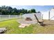 Landscaped backyard featuring a fire pit with seating at 3281 Enclave Blvd, Mulberry, FL 33860