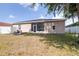 View of the home's rear exterior and the fenced-in yard at 3281 Enclave Blvd, Mulberry, FL 33860