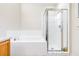 This is a bathroom showcasing a tiled bathtub and a glass-enclosed shower stall at 3281 Enclave Blvd, Mulberry, FL 33860