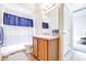 Bathroom featuring a blue and white shower curtain, toilet, and vanity with wooden cabinets at 3281 Enclave Blvd, Mulberry, FL 33860