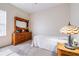 Cozy bedroom is furnished with a wooden dresser, a decorative lamp, and a comfortable bed at 3281 Enclave Blvd, Mulberry, FL 33860