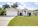Charming single-story home with manicured lawn, well-lit driveway and an attached two car garage at 3281 Enclave Blvd, Mulberry, FL 33860