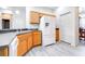 Bright kitchen featuring light oak cabinets, light gray floors, and stainless steel appliances at 3281 Enclave Blvd, Mulberry, FL 33860