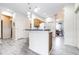 Bright kitchen featuring light oak cabinets, light gray floors, and stainless steel appliances at 3281 Enclave Blvd, Mulberry, FL 33860