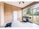 Enclosed lanai featuring a barbecue grill and view of the backyard at 3281 Enclave Blvd, Mulberry, FL 33860