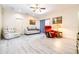 Bright living room featuring new light gray floors, a ceiling fan, and neutral walls at 3281 Enclave Blvd, Mulberry, FL 33860