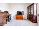 The living room features a wooden desk, a flat screen TV and a large cabinet with glass doors at 3281 Enclave Blvd, Mulberry, FL 33860