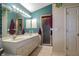 A bathroom with double sinks, shower, tile flooring, and plenty of storage space at 330 W Palmetto St, Lakeland, FL 33815