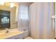 Cozy bathroom featuring a vanity, toilet and shower with a neutral color scheme at 330 W Palmetto St, Lakeland, FL 33815