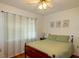 Cozy bedroom with natural light, featuring a ceiling fan and a comfortable bed with a green comforter at 330 W Palmetto St, Lakeland, FL 33815