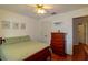 Inviting bedroom featuring wood floors, a ceiling fan, and a charming wood dresser for ample storage at 330 W Palmetto St, Lakeland, FL 33815