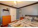 A bedroom with a gray and black bedding on a queen bed, wood flooring and ceiling fan at 330 W Palmetto St, Lakeland, FL 33815