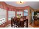 Warm breakfast nook with a table set near windows, showcasing a view towards the living area at 330 W Palmetto St, Lakeland, FL 33815