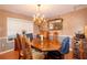 Elegant dining room featuring a wooden table, chandelier, mirror, and custom wall details at 330 W Palmetto St, Lakeland, FL 33815