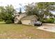 A two-story home with attached garage and a white vehicle parked in the driveway at 330 W Palmetto St, Lakeland, FL 33815