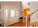 Bright foyer with hardwood floors, a front door with decorative glass, and a staircase at 330 W Palmetto St, Lakeland, FL 33815