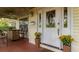 Inviting covered front porch with seating, decorative door, and pleasant curb appeal at 330 W Palmetto St, Lakeland, FL 33815