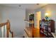 Well-lit hallway showcasing hardwood floors, a charming staircase, and a view into a cozy bedroom at 330 W Palmetto St, Lakeland, FL 33815