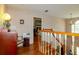 Spacious hallway with hardwood floors, a wooden staircase, and views into the neighboring bedrooms at 330 W Palmetto St, Lakeland, FL 33815